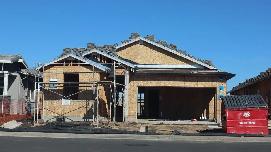 A new house under construction with visible scaffolding and materials.